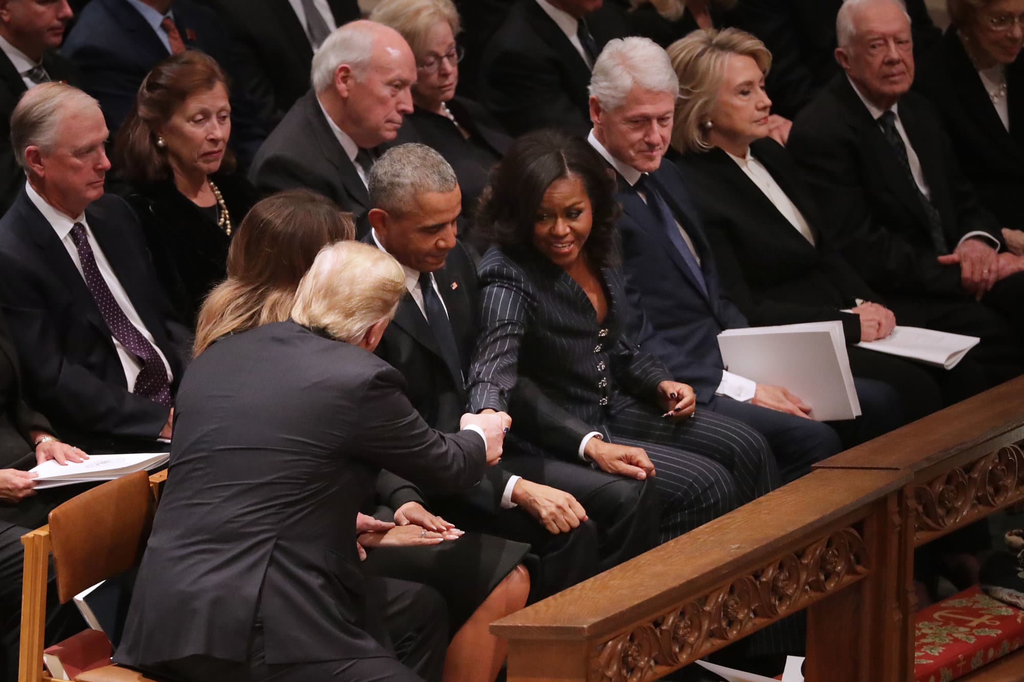 President Donald Trump and first lady Melania Trump greet former President Barack Obama and Michelle Obama as they join other former presidents and vice presidents and their spouses for the state funeral for former President George H.W. Bush at the National Cathedral December 05, 2018 in Washington, DC. A WWII combat veteran, Bush served as a member of Congress from Texas, ambassador to the United Nations, director of the CIA, vice president and 41st president of the United States.  (Photo by Chip Somodevilla/Getty Images)