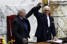 Maryland House Speaker Michael Busch, left, raises Senate President Thomas V. Mike Miller's arm before swearing-in ceremonies for Gov. Larry Hogan and Maryland Lt. Gov. Boyd Rutherford in the State Senate chamber, Wednesday, Jan. 16, 2019, in Annapolis, Md. (AP Photo/Patrick Semansky)