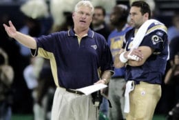 St. Louis Rams head coach Mike Martz and Kurt Warner stand along the sidelines in St. Louis during the Rams game against the Dallas Cowboys, Sept. 29, 2002. Warner suffered a broken bone in his pinkie finger during the game  (AP Photo/James A. Finley)