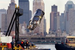 From the deck of the U.S. Army Corps of Engineers Hayward, the engine of US Airlines Flight 1549 that crash landed into the water on Jan. 15 can be seen as it is retrieved from the icy Hudson River in New York Friday, Jan. 23, 2009. (AP Photo/Craig Ruttle)