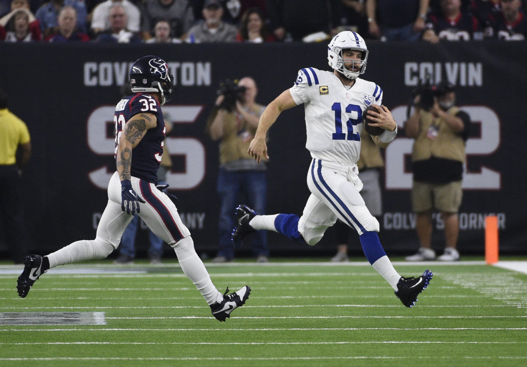 Indianapolis Colts quarterback Andrew Luck (12) runs as Houston Texans free safety Tyrann Mathieu (32) peruses during the second half of an NFL wild card playoff football game, Saturday, Jan. 5, 2019, in Houston. (AP Photo/Eric Christian Smith)