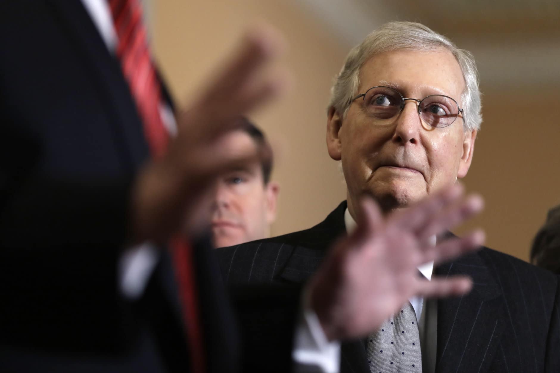 Senate Majority Leader Mitch McConnell of Ky., listens as President Donald Trump talks to the media after a Senate Republican policy lunch on Capitol Hill, Wednesday, Jan. 9, 2018, in Washington. (AP Photo/ Evan Vucci)