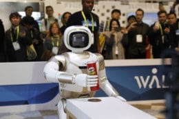 The Walker robot picks up a can of Pringles during a demonstration at the Ubtech booth at CES International, Wednesday, Jan. 9, 2019, in Las Vegas. (AP Photo/John Locher)