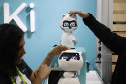 People touch Kiki robots at the Zoetic AI booth at CES International, Wednesday, Jan. 9, 2019, in Las Vegas. (AP Photo/John Locher)