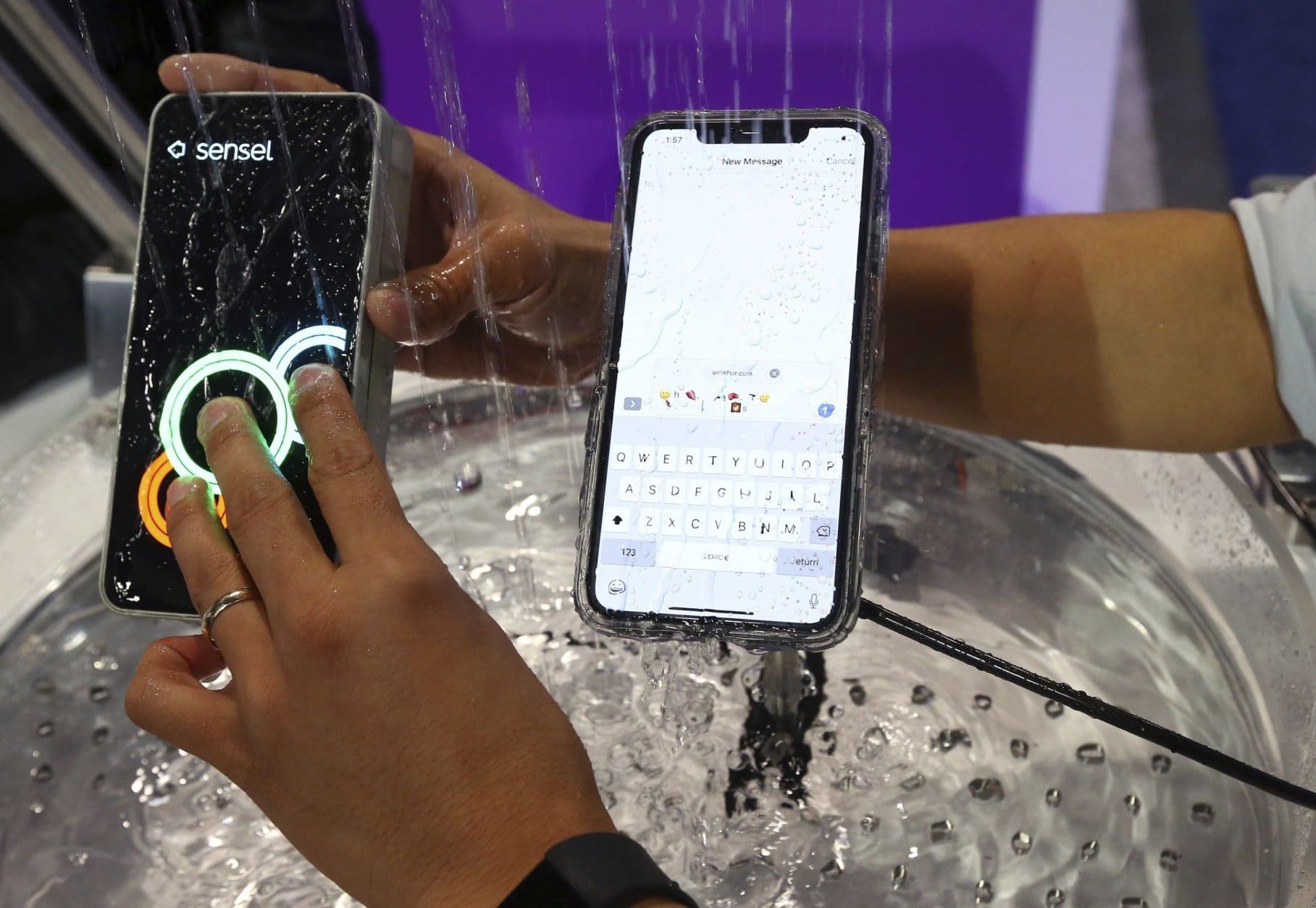 Sensel shows off its latest touch technology running water over a device to demonstrate that it still works, at CES International Wednesday, Jan. 9, 2019, in Las Vegas. (AP Photo/Ross D. Franklin)