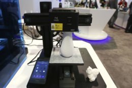 The Dobot Mooz multi-functional modular 3D printer works on a new project at CES International, Wednesday, Jan. 9, 2019, in Las Vegas. (AP Photo/Ross D. Franklin)