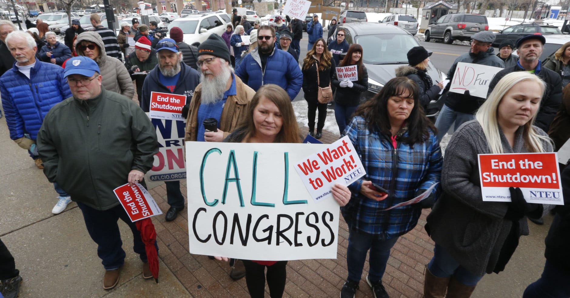 IRS worker Angela Gran, center, and others participate in a federal workers protest rally outside the Federal Building, Thursday, Jan., 10, 2019, in Ogden, Utah. Payday will come Friday without any checks for about 800,000 federal employees affected by the government shutdown, forcing workers to scale back spending, cancel trips, apply for unemployment benefits and take out loans to stay afloat. (AP Photo/Rick Bowmer)