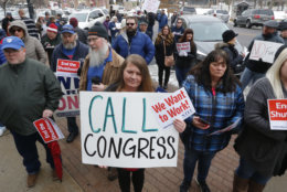IRS worker Angela Gran, center, and others participate in a federal workers protest rally outside the Federal Building, Thursday, Jan., 10, 2019, in Ogden, Utah. Payday will come Friday without any checks for about 800,000 federal employees affected by the government shutdown, forcing workers to scale back spending, cancel trips, apply for unemployment benefits and take out loans to stay afloat. (AP Photo/Rick Bowmer)