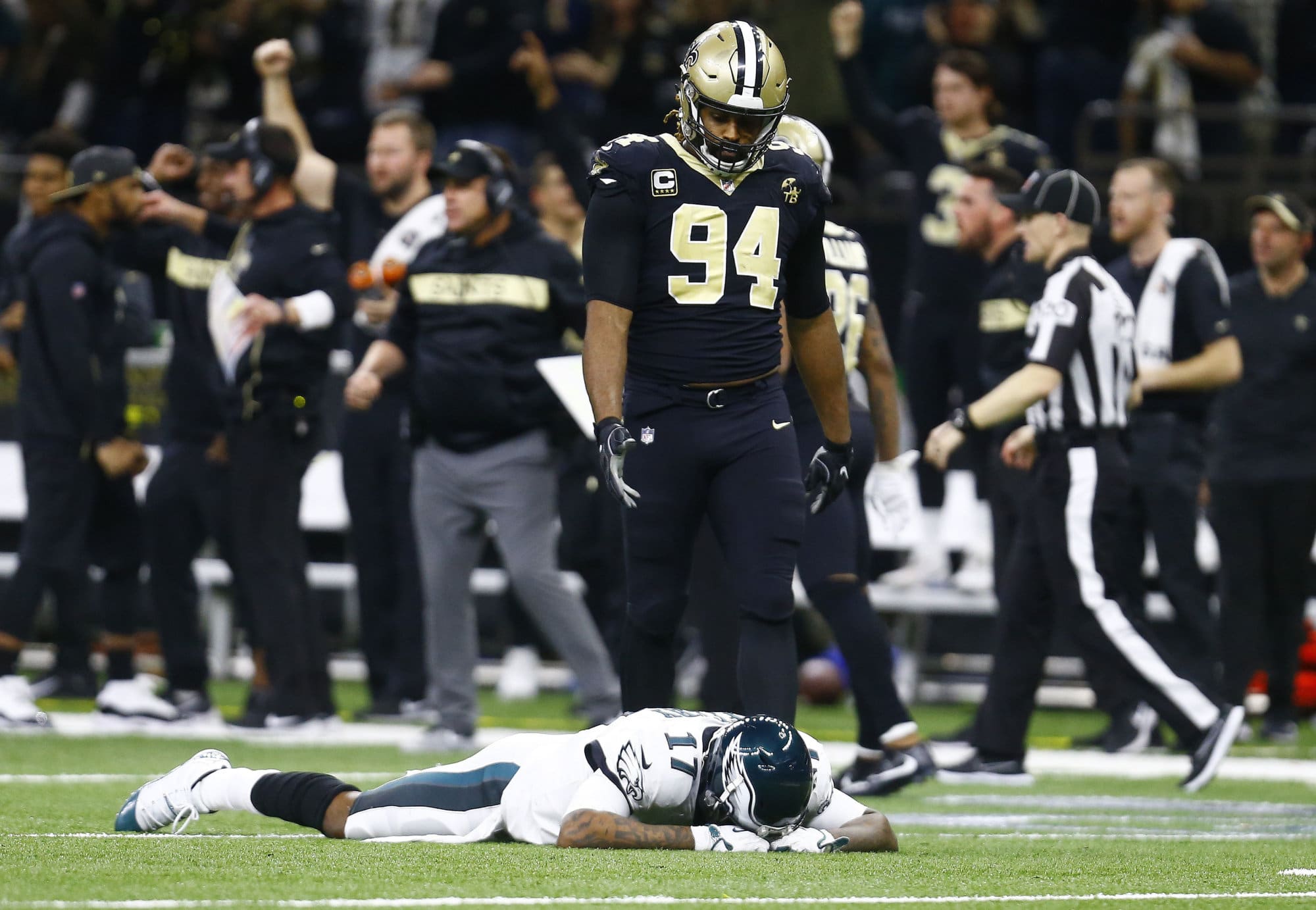 Philadelphia Eagles wide receiver Alshon Jeffery (17) lies on the turf in front of New Orleans Saints defensive end Cameron Jordan (94) after the Saints intercepted a pass in the second half of an NFL divisional playoff football game in New Orleans, Sunday, Jan. 13, 2019. The Saints won 20-14. (AP Photo/Butch Dill)