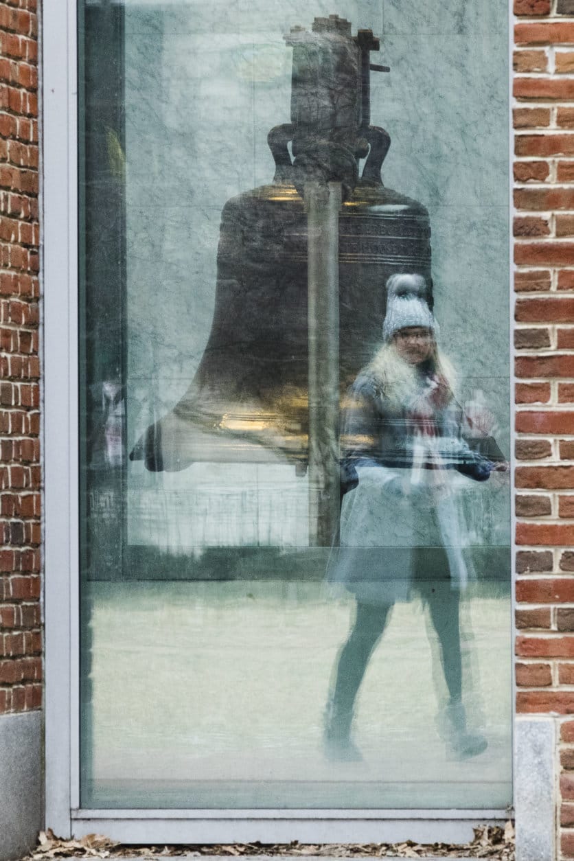 A tourist is reflected in a window of the closed building housing the Liberty Bell, in Philadelphia, Wednesday, Jan. 16, 2019. The building is closed due to the partial government shutdown. (AP Photo/Matt Rourke)
