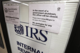Doors at the Internal Revenue Service (IRS) in the Henry M. Jackson Federal Building are locked and covered with blinds as a sign posted advises that the office will be closed during the partial government shutdown Wednesday, Jan. 16, 2019, in Seattle. The shutdown is in its fourth week with no end in sight. (AP Photo/Elaine Thompson)