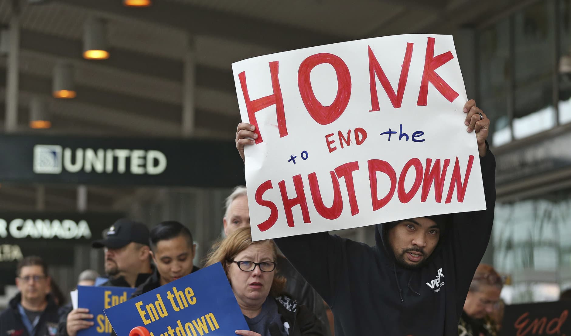 More than two dozen federal employees and supporters demonstrate at the Sacramento International Airport calling for President Donald Trump and Washington lawmakers to end then partial government shutdown, Wednesday, Jan. 16, 2019, in Sacramento, Calif. (AP Photo/Rich Pedroncelli)