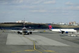 An American Airlines jet, left, waits for a Delta Airlines jet to pass by before following it onto the runway at LaGuardia Airport, Friday, Jan. 25, 2019, in New York. The Federal Aviation Administration reported delays in air travel Friday because of a "slight increase in sick leave" at two East Coast air traffic control facilities. (AP Photo/Julio Cortez)