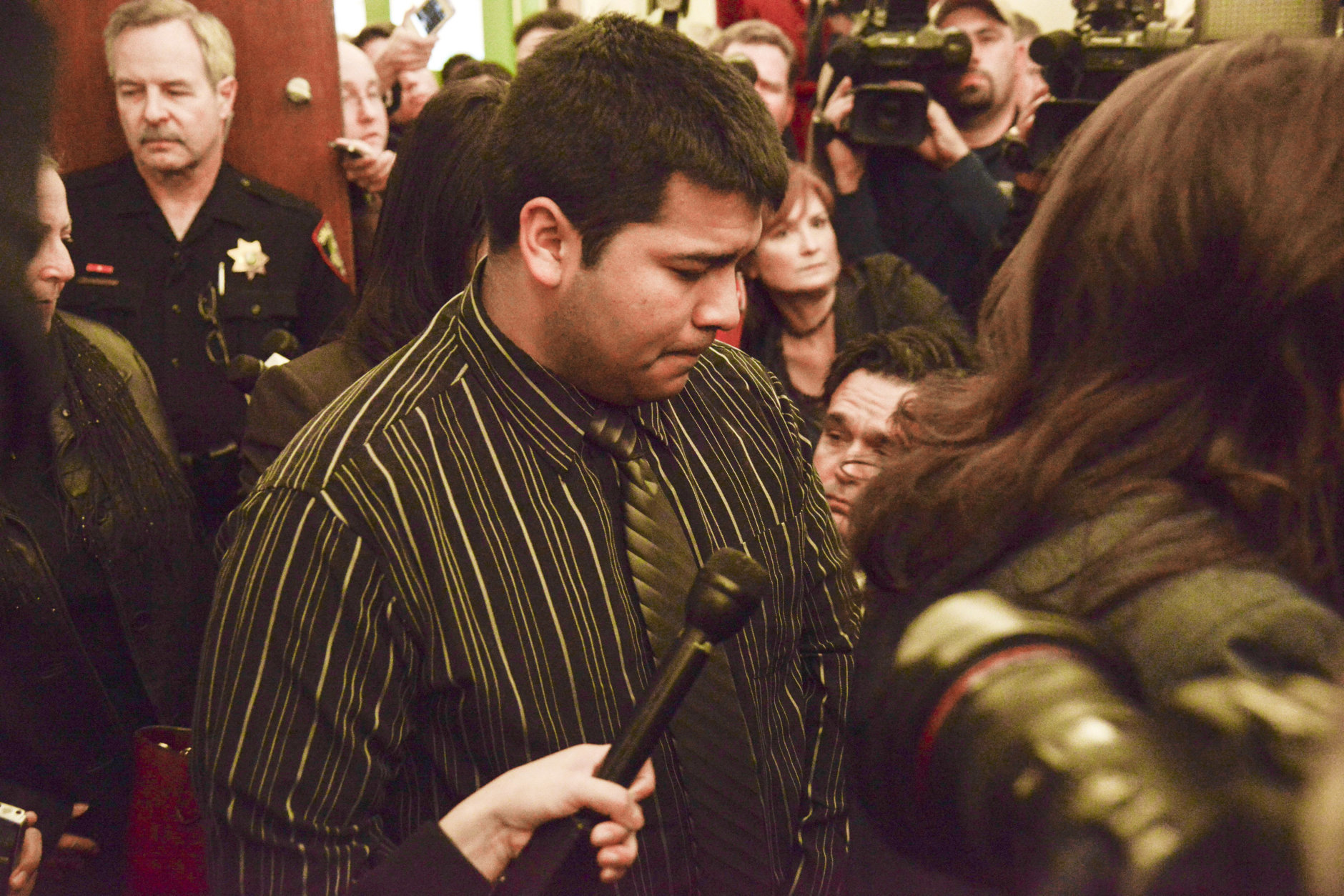 FILE - In this Jan. 24, 2014 file photo, Erick Munoz, husband of Marlise Munoz, is escorted out of court by his attorney Heather L. King, right, in Fort Worth, Texas.  Before Marlise Munoz, a pregnant brain-dead Texas woman was taken off life support over the weekend at the end of a long legal battle, her husband said he decided to name what would have been the couple's second child. Erick Munoz said Monday, Jan. 27,  he gave the 23-week-old fetus the name Nicole, the middle name of his late wife. He would not say why he chose to name the fetus. (AP Photo/Tim Sharp, File)