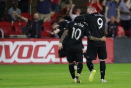 WASHINGTON, DC - JULY 14: Wayne Rooney #9 and Luciano Acosta #10 of D.C. United celebrate after Paul Arriola #7 (not pictured) scored a goal in the second half against the Vancouver Whitecaps at Audi Field on July 14, 2018 in Washington, DC. (Photo by Patrick McDermott/Getty Images)