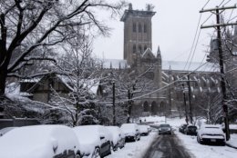 Despite the possibility of more snow, cleanup efforts were already underway and moving at a quick pace in most of D.C. Roadways impassable overnight were largely cleared of snow by mid-morning, though work continued on side streets such as this one near the National Cathedral. (WTOP/Alejandro Alvarez)