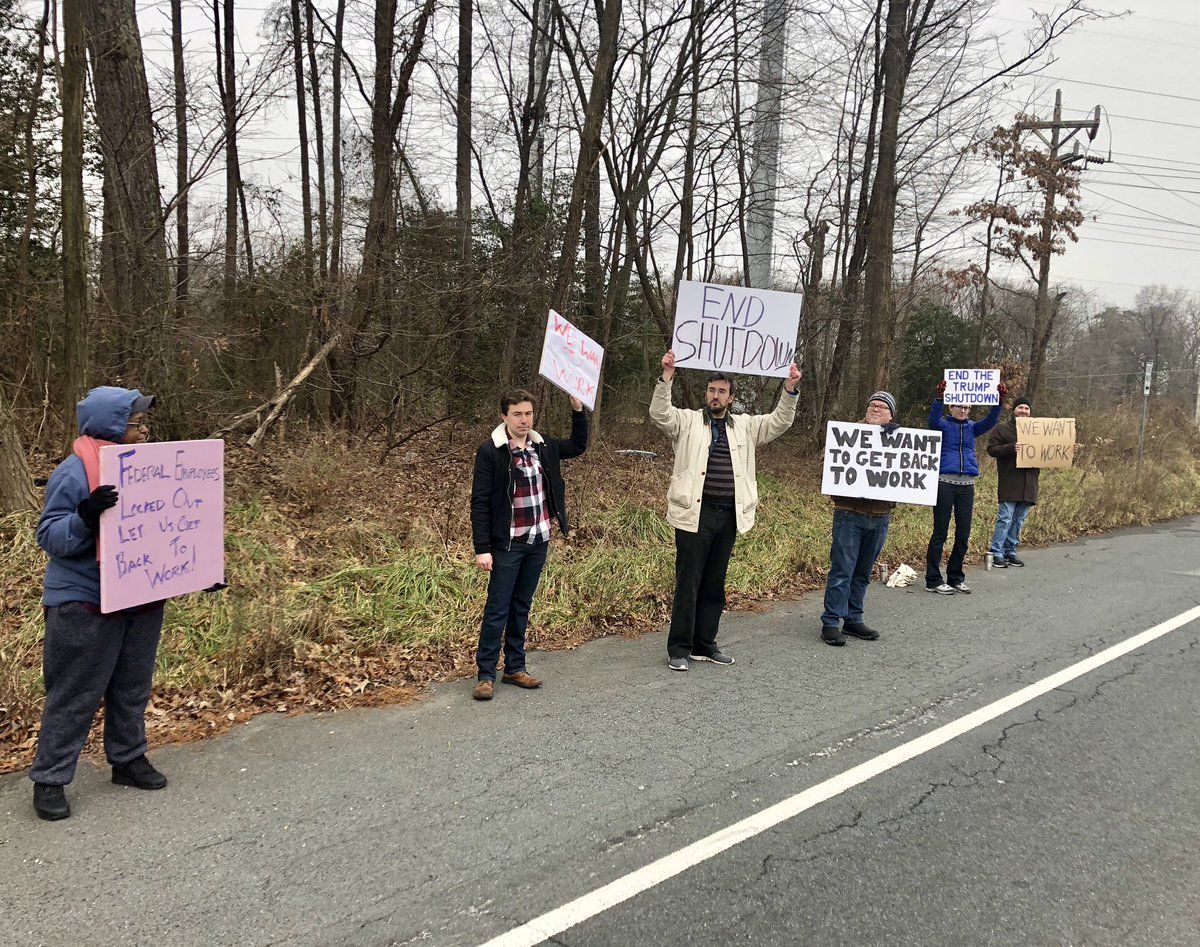 A group of furloughed feds hold a protest against government shutdown in College Park, Maryland, on Adelphi Road. (WTOP/Nick Iannelli) 