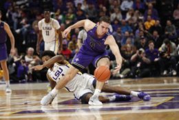 Furman guard Andrew Brown (5) chases down a loose ball against LSU guard Marlon Taylor in the first half an NCAA college basketball game in Baton Rouge, La., Friday, Dec. 21, 2018. (AP Photo/Gerald Herbert)