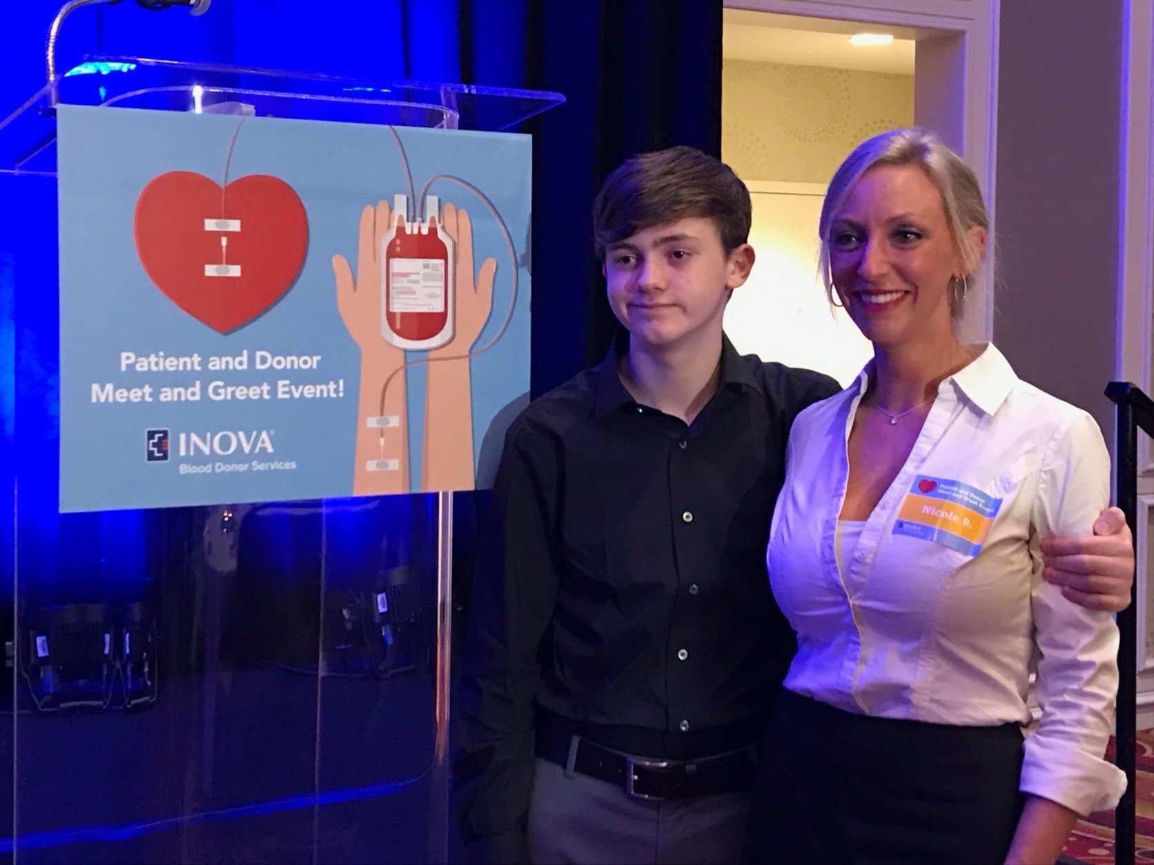 Tate Reynolds, 13, and his mother, Nicole Reynolds, meet some of the donors who helped save his life after he was accidentally stabbed in 2017. At the time, doctors weren't sure Tate Reynolds would survive. The donations from more than 80 people helped save him. (WTOP/Michelle Basch) 