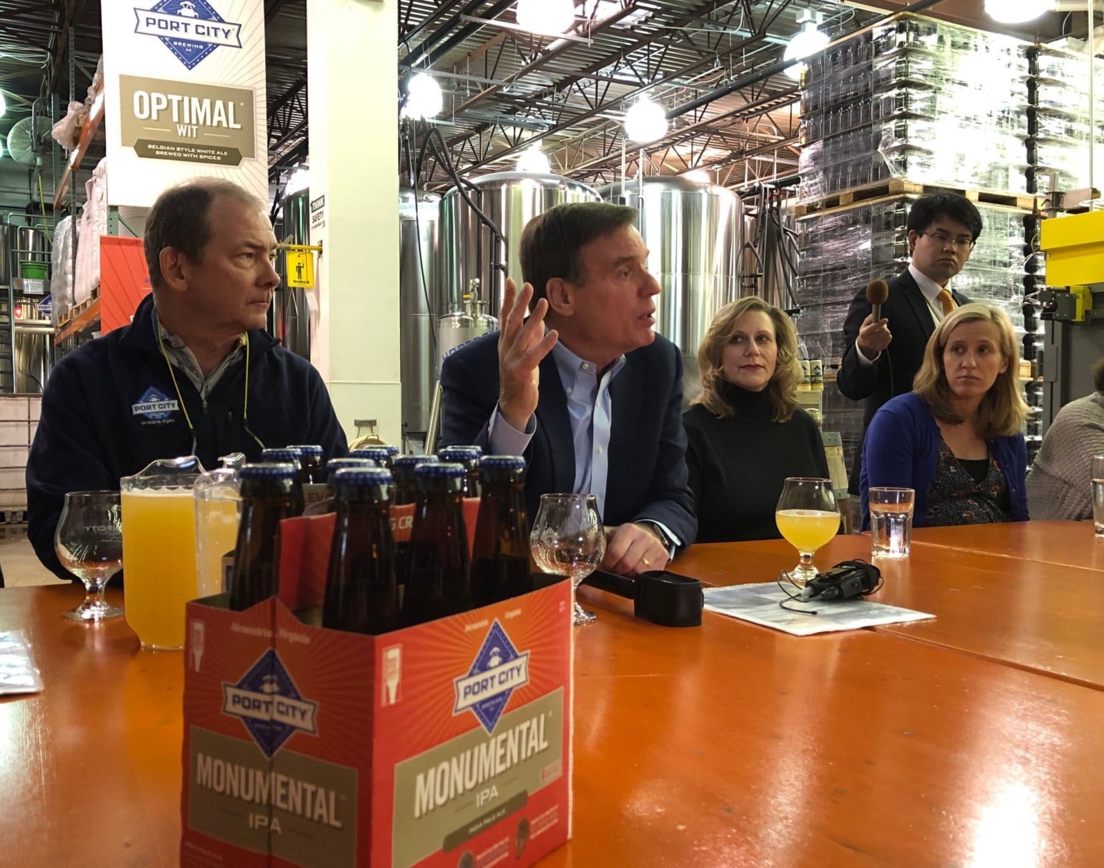 Sen. Mark Warner, D-Va., sponsored the gathering Wednesday at the Port City Brewing Company in Alexandria, Virginia, where founder and CEO Bill Butcher talked about issues shared by craft brewers locally and nationwide. (WTOP/Kristi King)