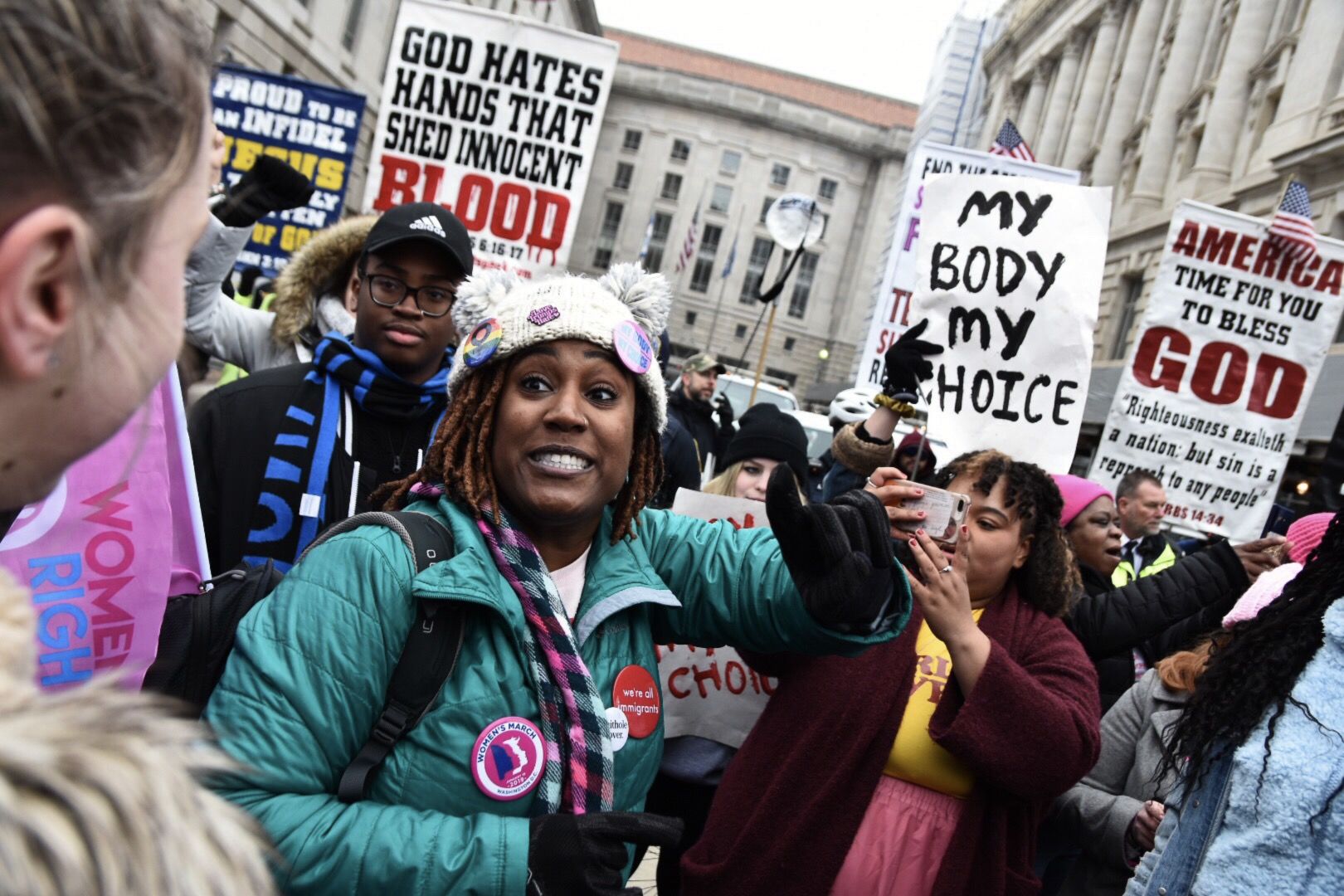 A group of marchers confront a small number of anti-abortion activists attempting to drown out the main rally with a megaphone. (WTOP/Alejandro Alvarez)
