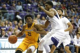 Lipscomb guard Kenny Cooper (21) drives inside as TCU center Kevin Samuel, right, defends during the first half of an NCAA college basketball game, Tuesday, Nov. 20, 2018, in Fort Worth, Texas. Lipscomb won 73-64. (AP Photo/Ron Jenkins)