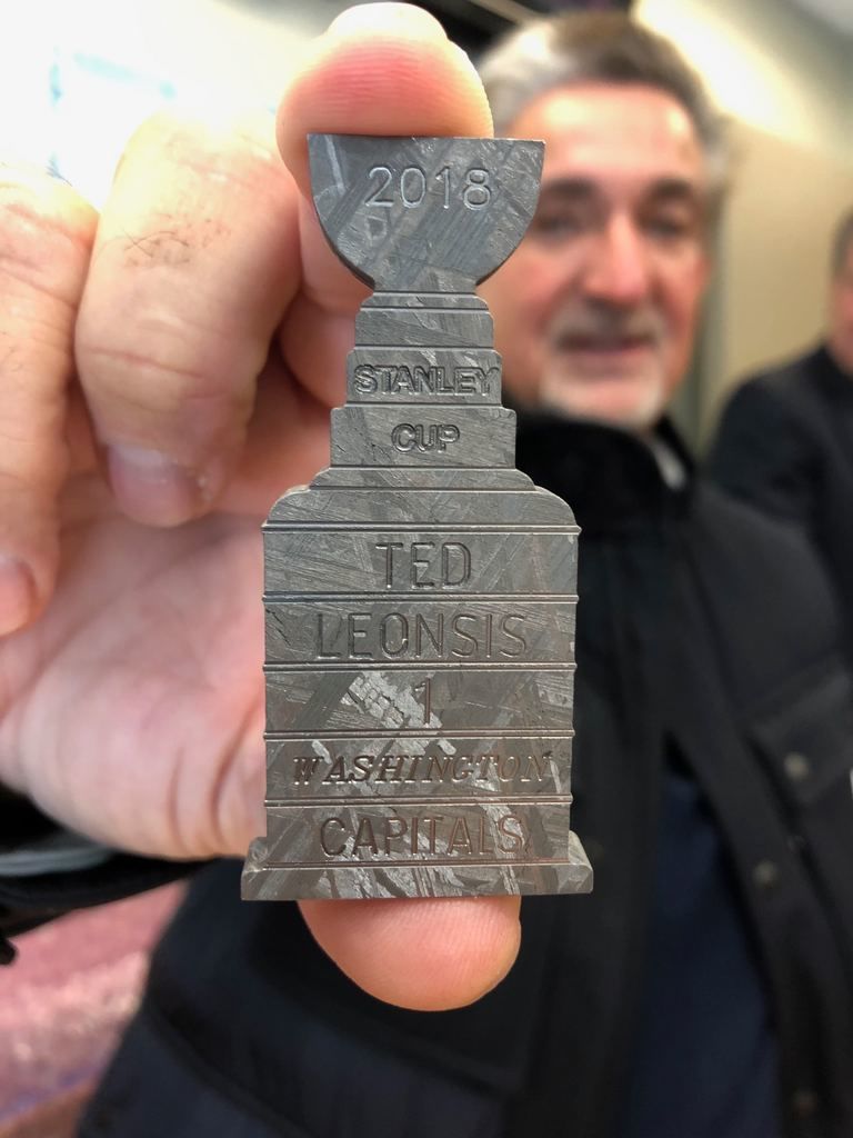 Monumental Sports CEO Ted Leonsis shows off a piece of a meteorite that a fan carved into a replica of the Stanley Cup and gave him as a gift. (WTOP/Julia Ziegler)