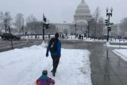 People make their way towards Capitol Hill for some sledding. (WTOP/Mitchell Miller)