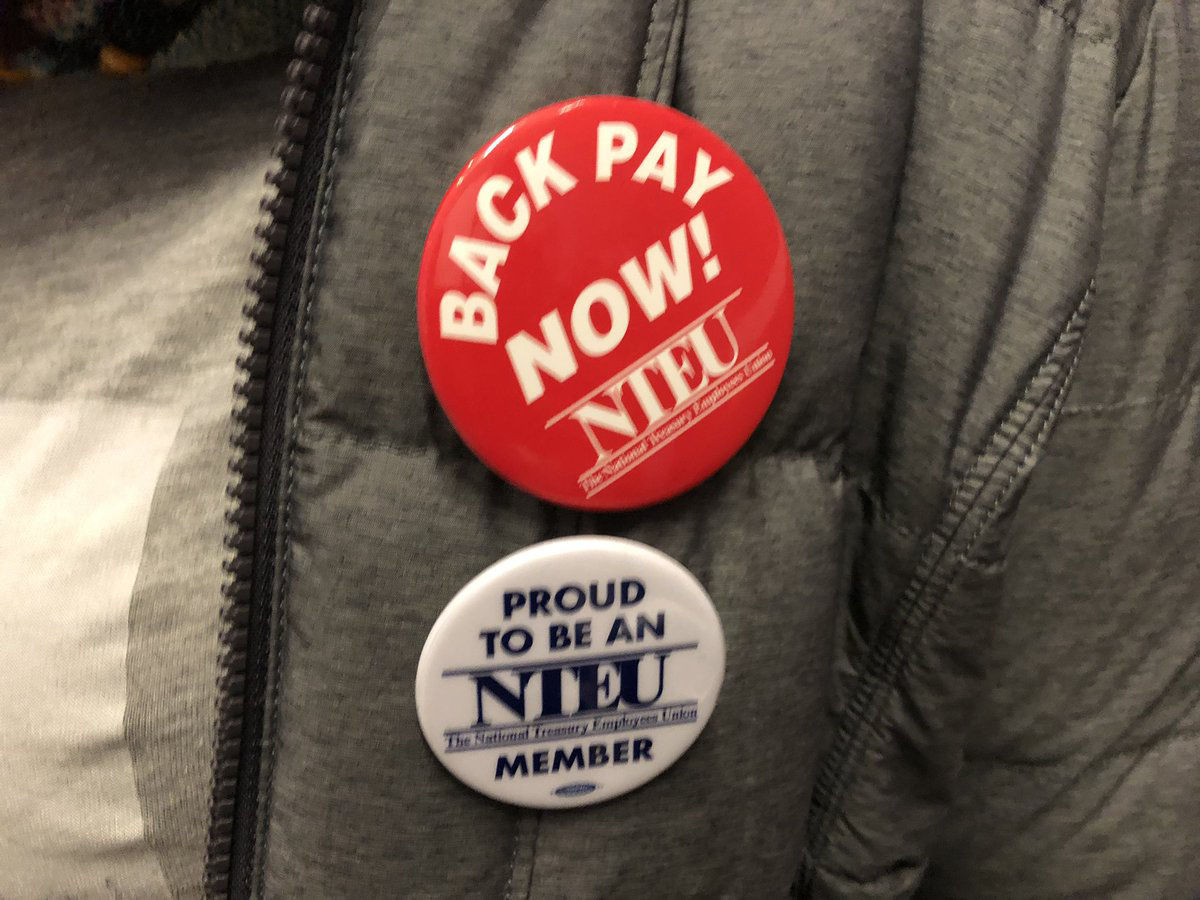 Buttons from the rally agains tthe government shutdown Jan. 10, 2019. (WTOP/Kristi King)