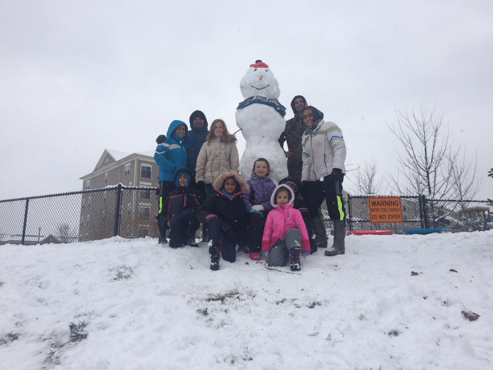 This WTOP listener said they helped make the "biggest snowman in the neighborhood" in Woodbridge, Virginia. There was also a lot of sledding involved. (Courtesy Kamaljit Chawla)