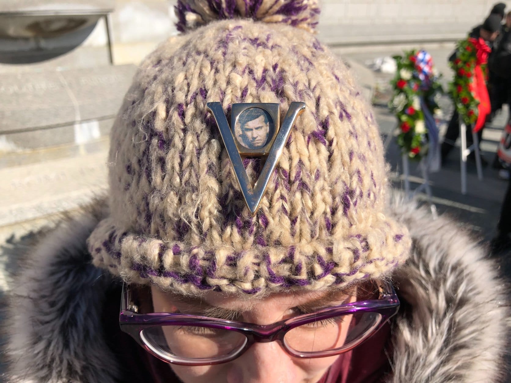 JoAnne Prasnick of Cleveland wears a victory pin depicting her father Aurther G. Prasnick, who survived the battles of Anzio and Rome. (WTOP/Kristi King)