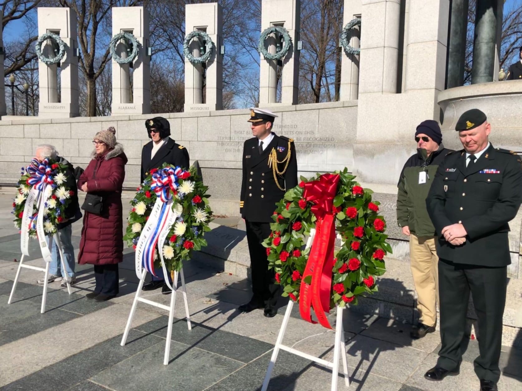 Helping lay the wreaths at the Tuesday ceremony were British and Canadian military dignitaries. From left: Chaplain Lt. Col. Todd Wolf; Cmdr. Richard McHugh; and Maj. Jeff Pederson. (WTOP/Kristi King)