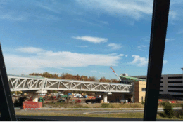 Placing Metal Roofing on Pedestrian Bridge at Loudoun Gateway Station (Courtesy/ Metropolitan Washington Airports Authority)