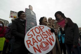 A group hold up signs at freedom plaza during the women's march in Washington on Saturday, Jan. 19, 2019. (AP Photo/Jose Luis Magana)