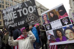 Demonstrators hold signs during the Women's March in Washington on Saturday, Jan. 19, 2019. (AP Photo/Jose Luis Magana)
