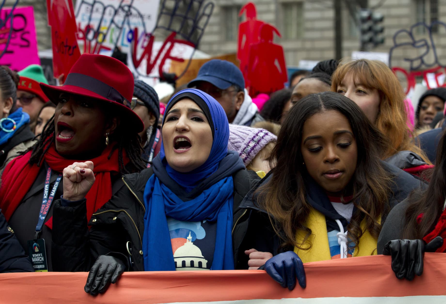 Co-presidents of the 2019 Women's March, Linda Sarsour, center, and Tamika Mallory, right, join other demonstrators on Pennsylvania Avenue during the Women's March in Washington on Saturday, Jan. 19, 2019. (AP Photo/Jose Luis Magana)