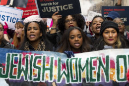 Co-president of the 2019 Women's March, Tamika Mallory, center, joins other demonstrators on Pennsylvania Avenue during the Women's March in Washington on Saturday, Jan. 19, 2019. (AP Photo/Jose Luis Magana)