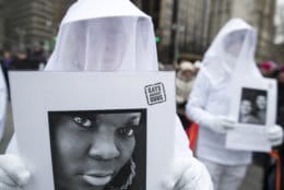 Demonstrators march with photos of people who died as a result of gun violence during the Women's March Alliance, Saturday, Jan. 19, 2019, in New York. (AP Photo/Mary Altaffer)