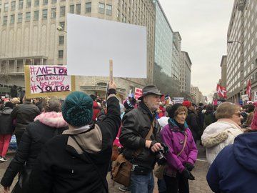 Protesters hold up signs at the 2019 annual Women's March in Washington, D.C. (WTOP/Melissa Howell)