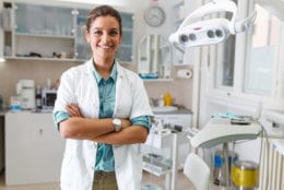 Portrait of female dentist .She standing in her dentist office..