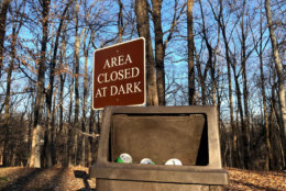 The lid of a trash can is left open as trash peeks out at Rock Creek Park on Thursday, Jan. 10, 2019. (WTOP/Mike Murillo)