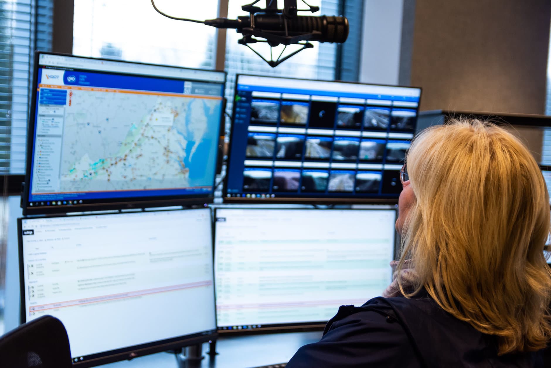 WTOP traffic reporter Mary de Pompa at her work station in the new Traffic Center. With more screens and updated technology, the Traffic Center will be able to monitor more camera and scanner feeds for a wider view of the situation on the roads. (WTOP/Alejandro Alvarez)