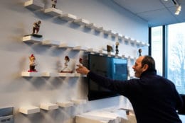 The start of a new era: WTOP sports anchor Jonathan Warner brings the sport desk's army of bobbleheads to their home. (WTOP/Alejandro Alvarez)