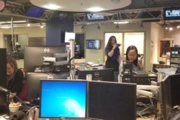 Editor Sae Robinson is on the phone with Editor Ana Srikanth who is in the new building. The transition is complete. (WTOP/Albert Shimabukuro) 