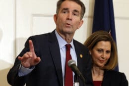 Virginia Gov. Ralph Northam, left, gestures as his wife, Pam, listens during a news conference in the Governors Mansion at the Capitol in Richmond, Va., Saturday, Feb. 2, 2019. Northam is under fire for a racial photo the appeared in his college yearbook. (AP Photo/Steve Helber)