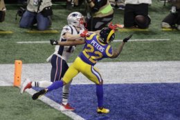 New England Patriots' Chris Hogan (15) is defended by Los Angeles Rams' Marcus Peters (22) during the first half of the NFL Super Bowl 53 football game Sunday, Feb. 3, 2019, in Atlanta. (AP Photo/Charlie Riedel)