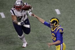 Los Angeles Rams' Jared Goff (16) throws the ball under pressure from New England Patriots' Danny Shelton (71) during the first half of the NFL Super Bowl 53 football game Sunday, Feb. 3, 2019, in Atlanta. (AP Photo/Charlie Riedel)
