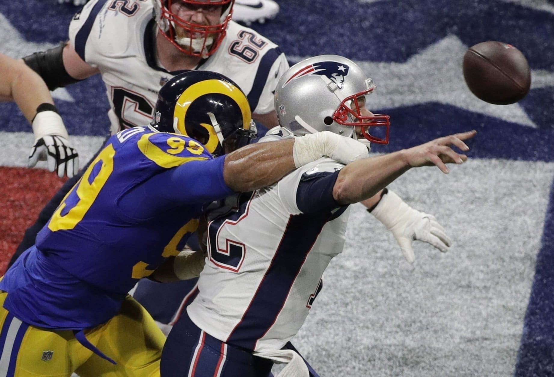 Los Angeles Rams' Aaron Donald (99) hits New England Patriots' Tom Brady (12) during the first half of the NFL Super Bowl 53 football game Sunday, Feb. 3, 2019, in Atlanta. (AP Photo/Charlie Riedel)