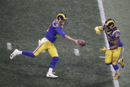 Los Angeles Rams' Jared Goff (16) hands the ball off to Los Angeles Rams' Todd Gurley II during the second half of the NFL Super Bowl 53 football game against the New England Patriots, Sunday, Feb. 3, 2019, in Atlanta. (AP Photo/Charlie Riedel)