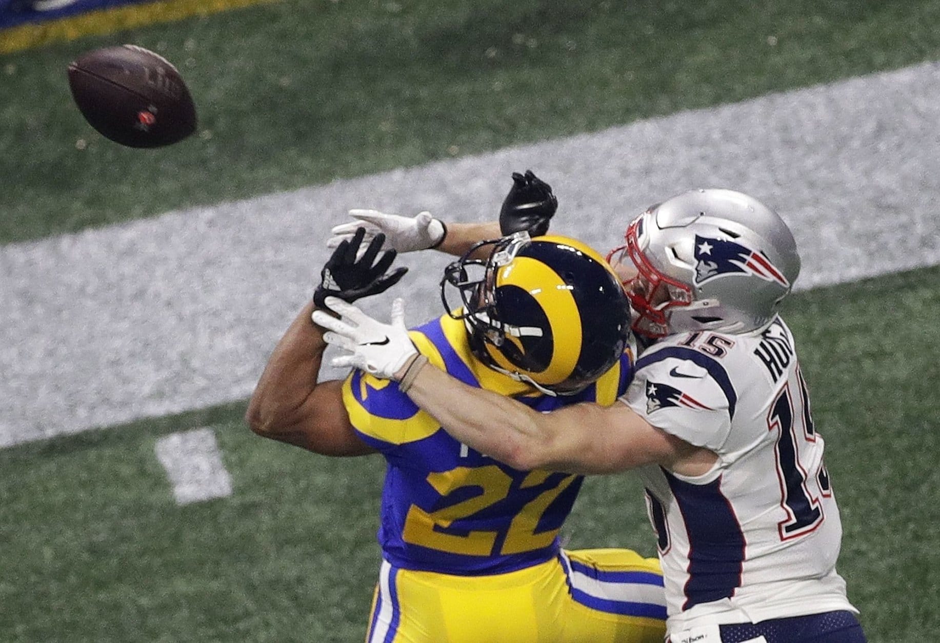 Los Angeles Rams' Marcus Peters (22) breaks up a pass intended for New England Patriots' Chris Hogan (15) during the second half of the NFL Super Bowl 53 football game Sunday, Feb. 3, 2019, in Atlanta. (AP Photo/Charlie Riedel)